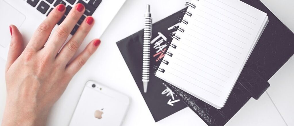 Woman hand smartphone desk